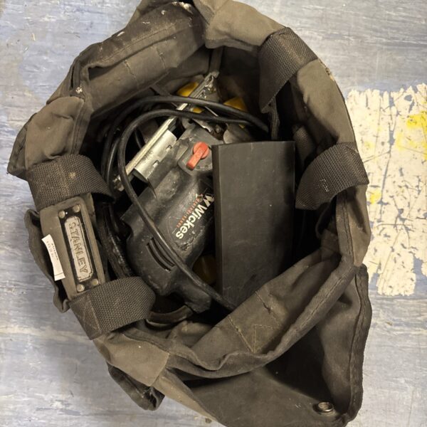 Black Stanley toolbag containing a Wickes jigsaw and screwdrivers.