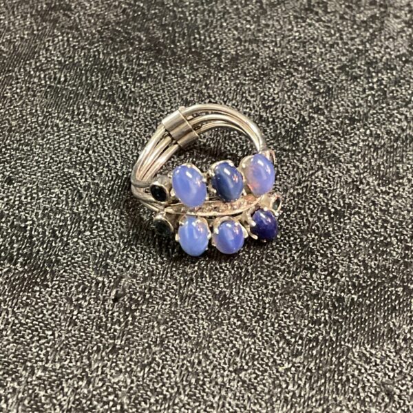 Close-up of a vintage star sapphire and diamond ring in white gold.