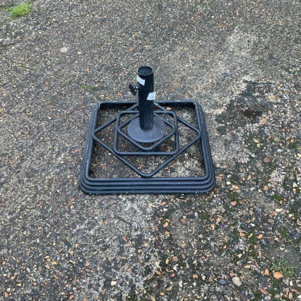 Heavy iron Stonington umbrella base for outdoor patio use.