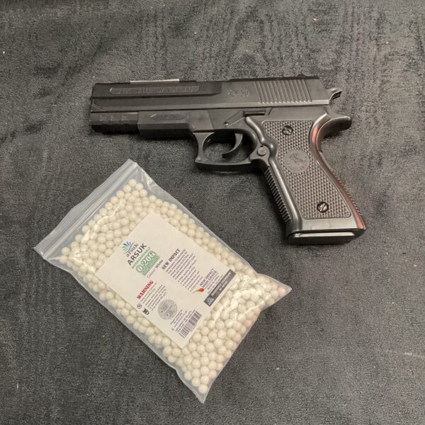 S&W airsoft pistol with airsoft ammunition pellets displayed.