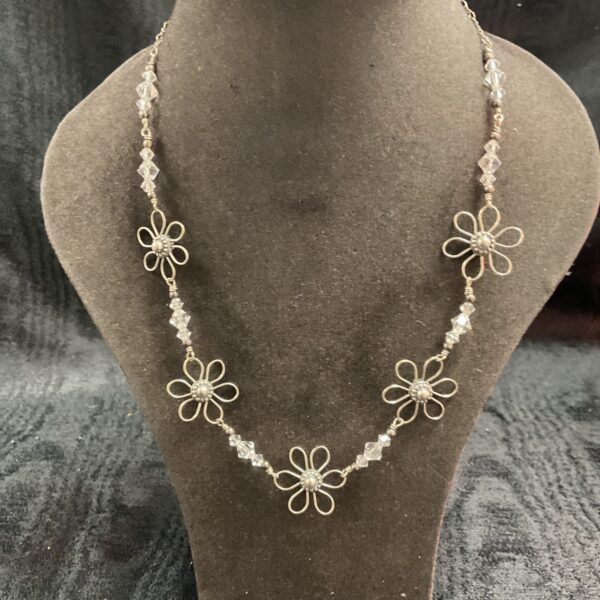 Delicate Swarovski crystal flower necklace on a silver chain.
