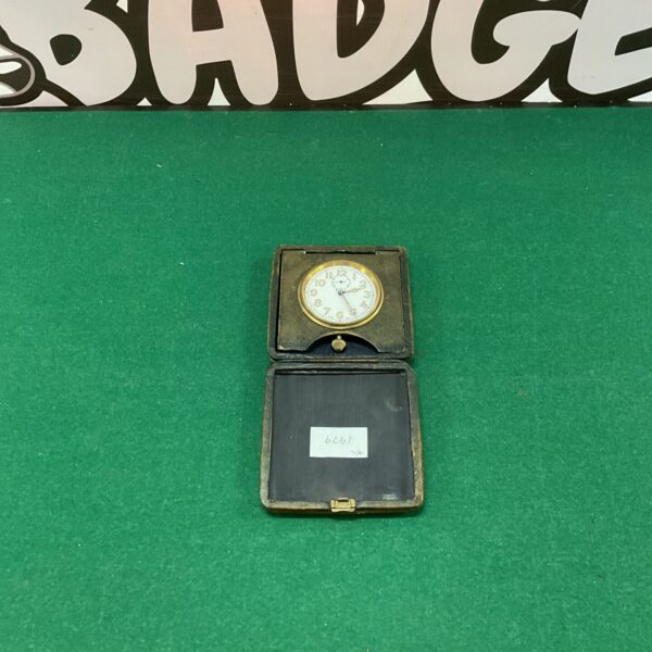 Vintage Swiss travel clock with brass folding case.