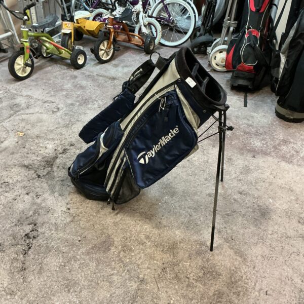 TaylorMade golf bag with multiple pockets, showing signs of wear.
