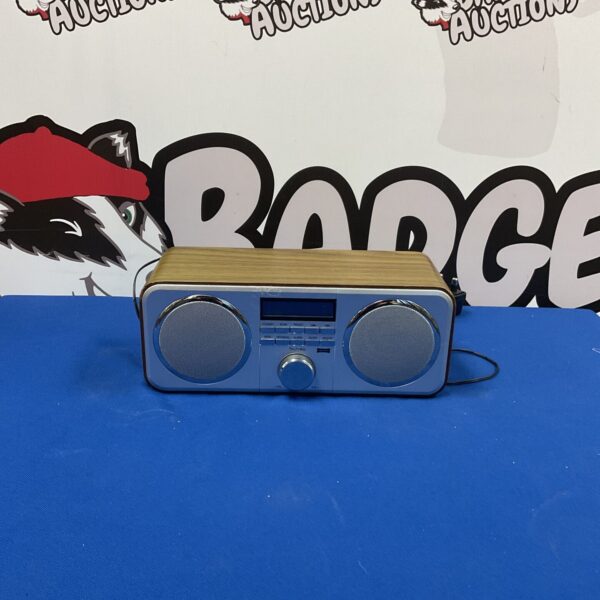 Grey Technika alarm radio with a damaged aerial, vintage style.