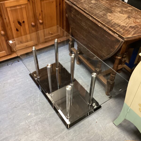 Clear tempered glass coffee table with metal legs.