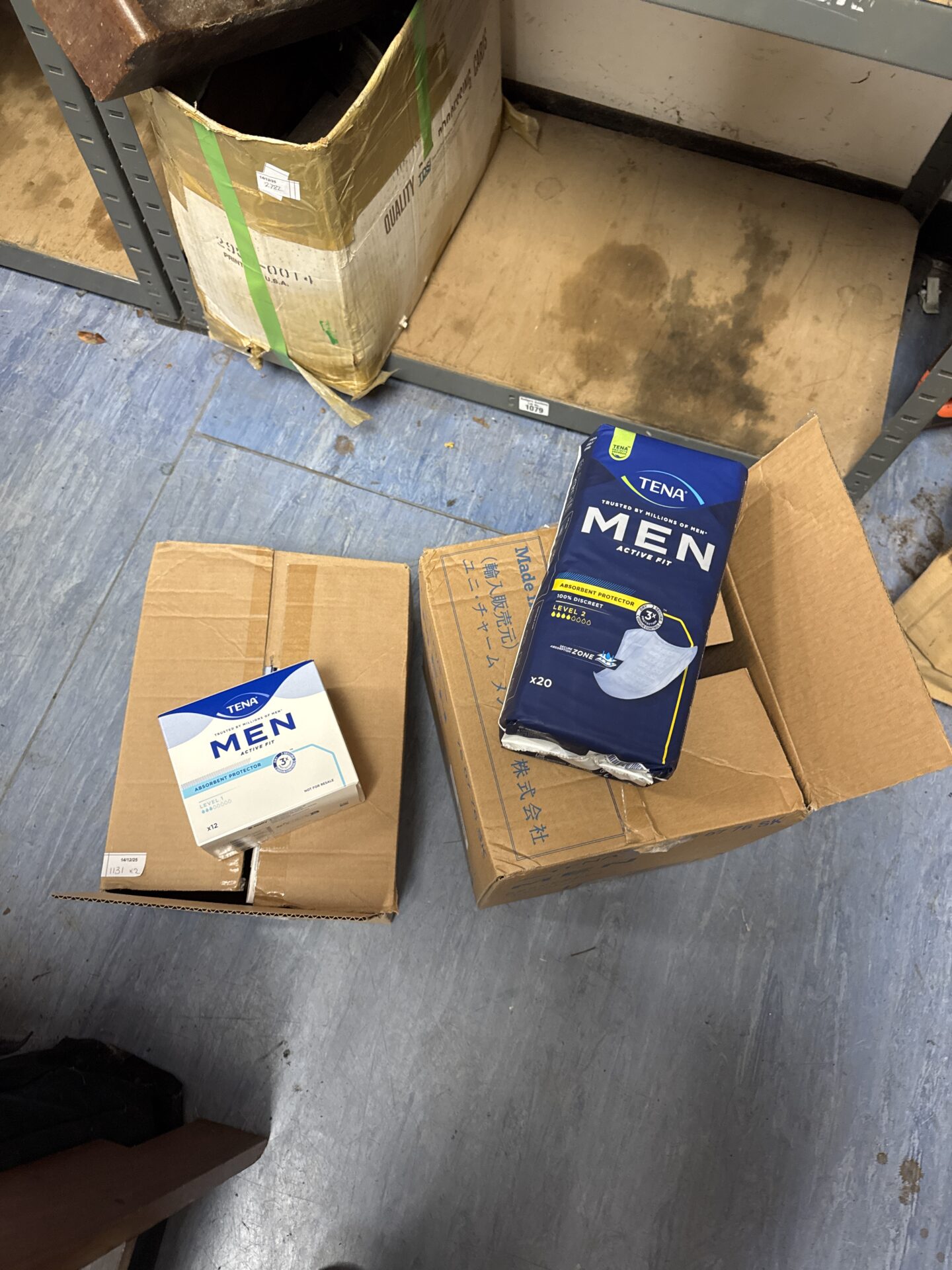 Two boxes of Tena Men Active Pads for incontinence protection.