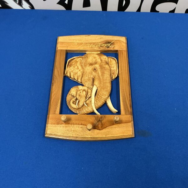 Detailed hand-carved Thai elephant wall plaque for home decor.