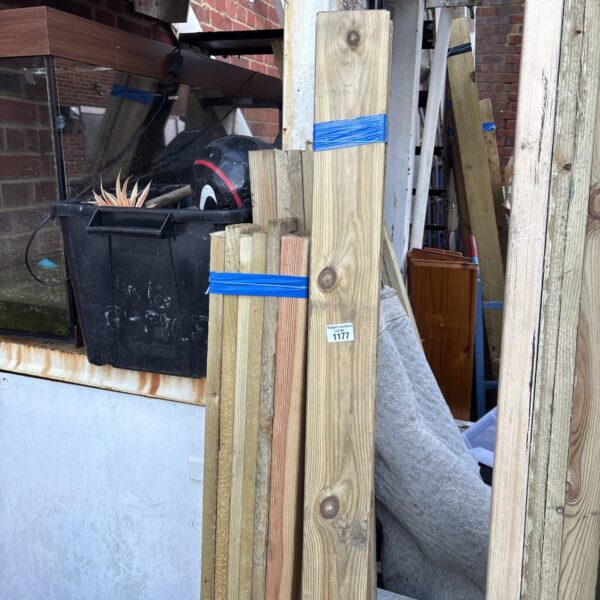 Three bundles of approximately 4ft timber for construction projects.