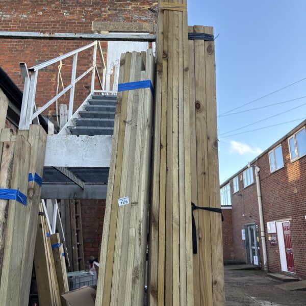 Two bundles of 9ft timber stacked outdoors, ready for construction.