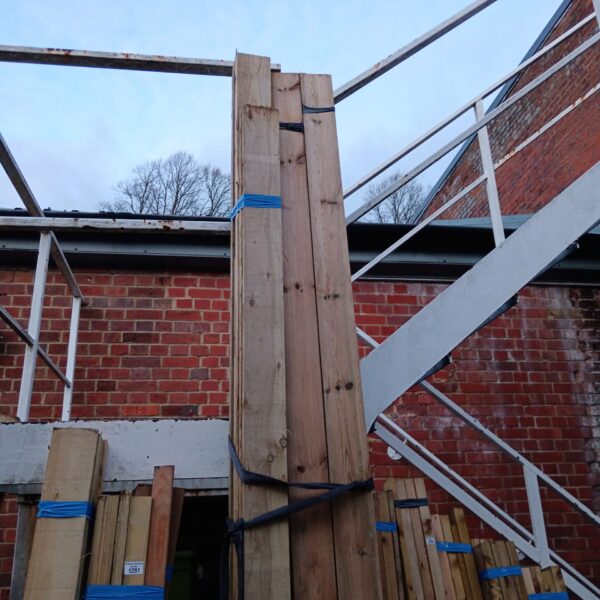 Strapped bundles of 10ft timber for construction projects.