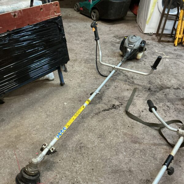 Used Titan petrol strimmer for garden maintenance and landscaping.