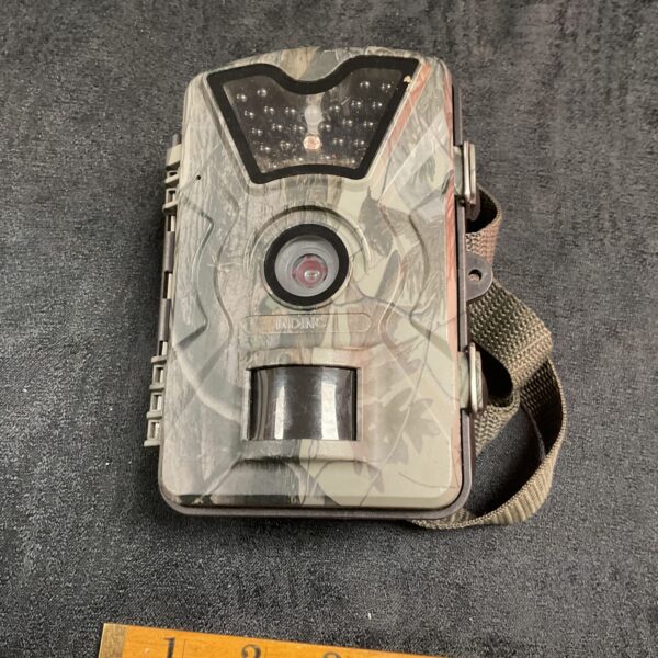 Camouflaged trail camera for outdoor wildlife observation.