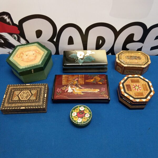 Overview of a collection of vintage trinket boxes with varied designs.