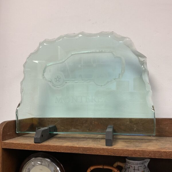 Side view of the etched glass Vauxhall Monterey plaque with other items.