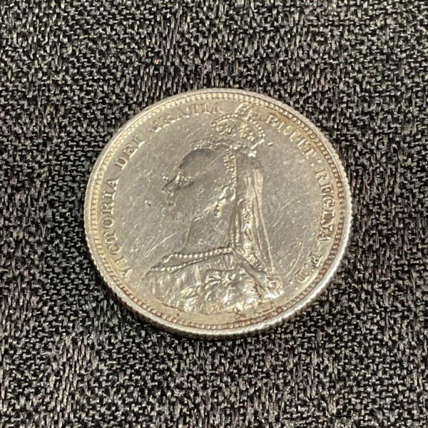 Close-up of the obverse of a Victorian 1887 silver shilling.