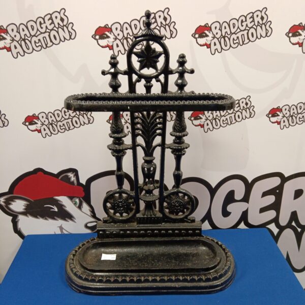 Ornate Victorian cast iron umbrella stand for hallway storage.