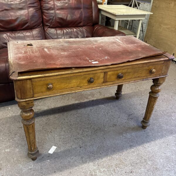 Antique Victorian writing desk with leather top and mahogany finish.