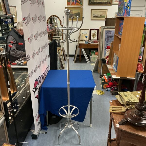 Vintage aluminium coat and hat stand in a hallway setting.