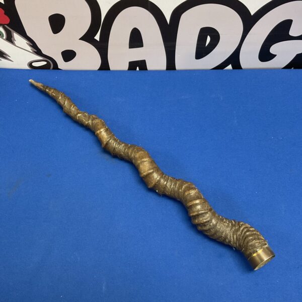 Polished vintage antelope horn with brass cuff for collectors.