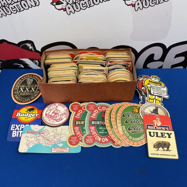 Large collection of vintage beer mats including Guinness and Badger brands.
