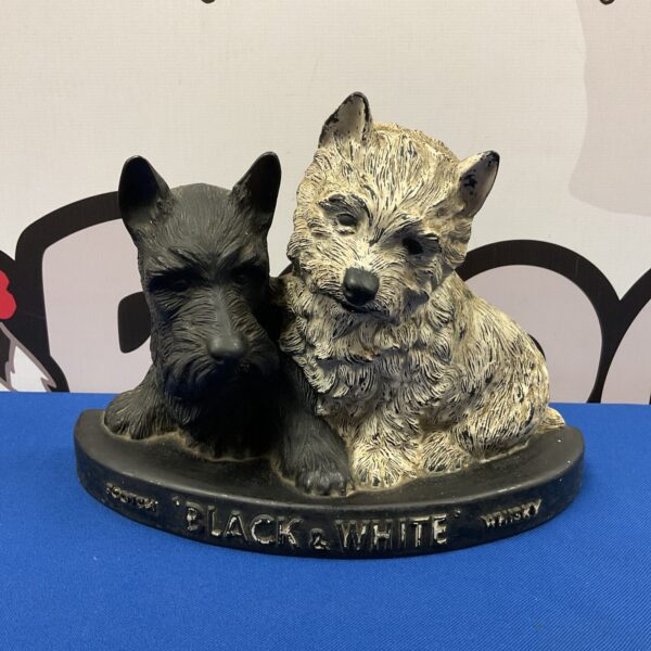 Vintage black and white plastic bar top dogs for scotch whiskey advertising.