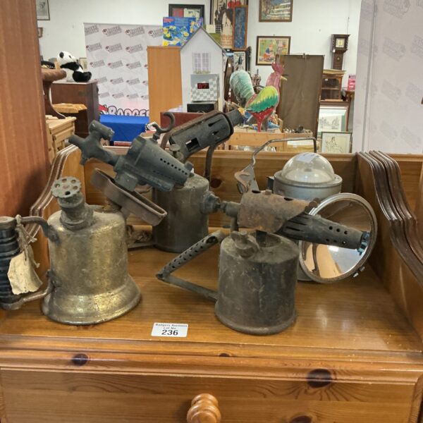 Vintage blow torch collection, antique brass workshop tools.