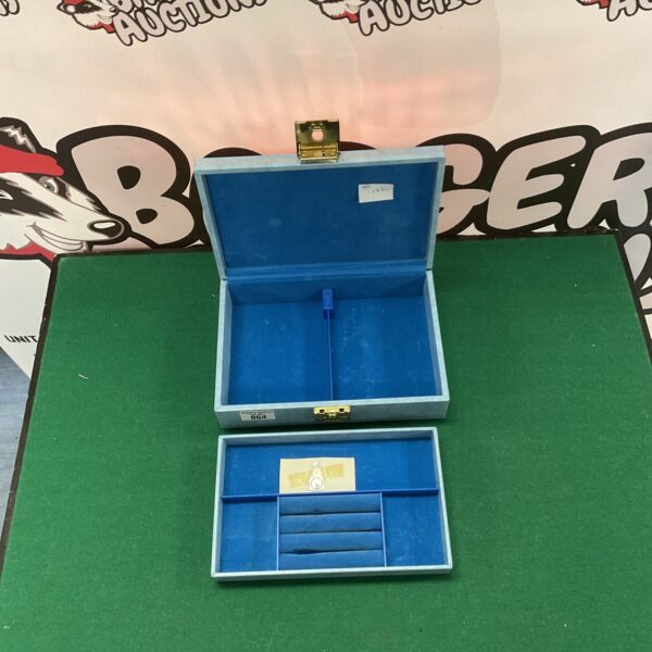 Open vintage blue jewellery box with two tiers.