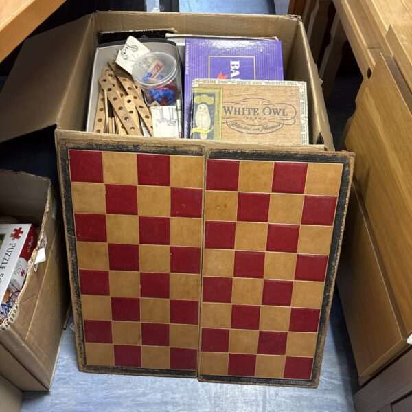 Vintage board games lot with chess set in cardboard box.