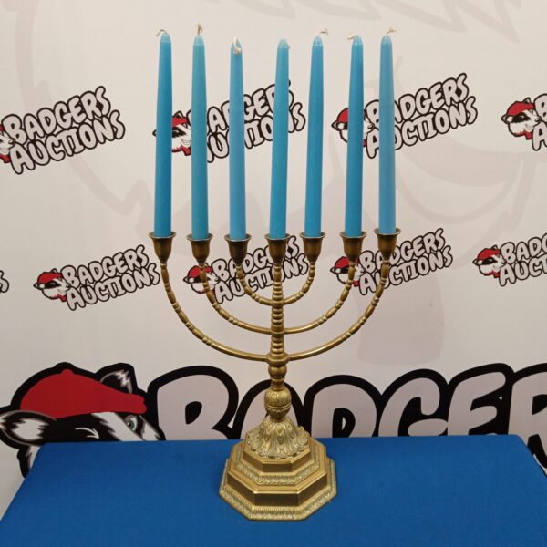 Tall vintage brass menorah candlestick for Hanukkah celebrations.