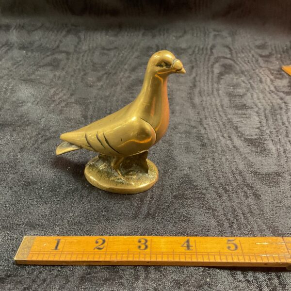 Detailed vintage brass pigeon statue, collectible bird figurine.