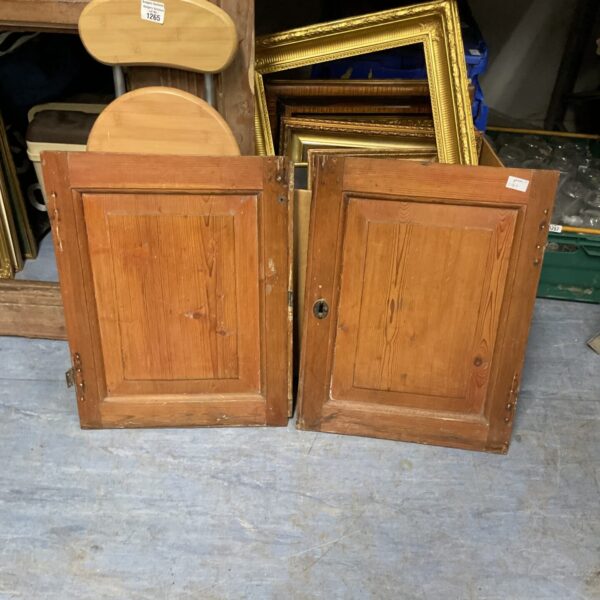Two vintage wooden cabinet doors with raised panels.