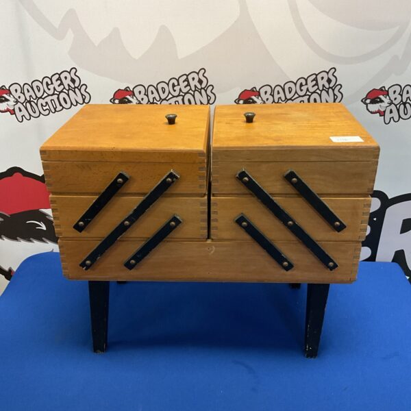 Vintage wooden cantilever sewing box with tiered compartments.