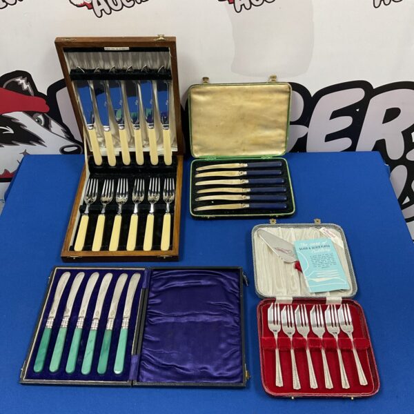 Vintage cased cutlery sets with silver plated mango handles.