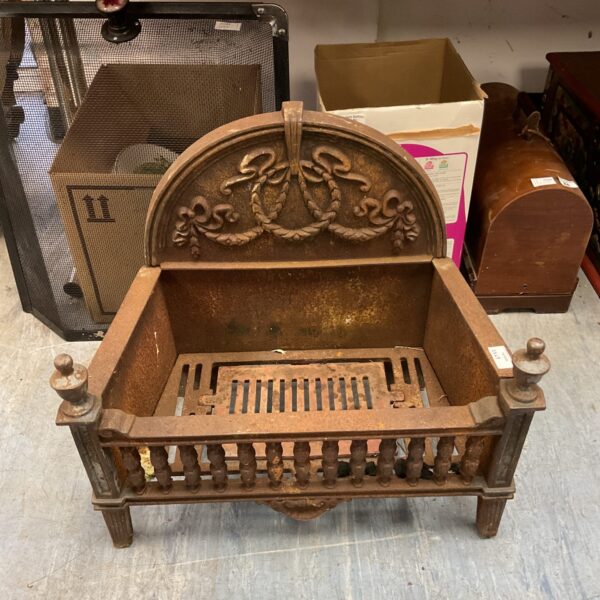 Vintage cast iron fire grate with rope pattern design.