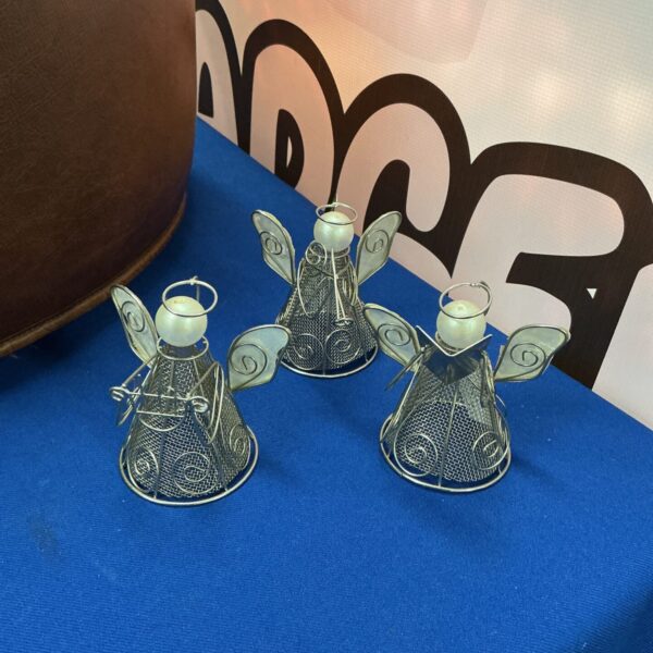 Three vintage wire Christmas angels, delicate holiday decorations.