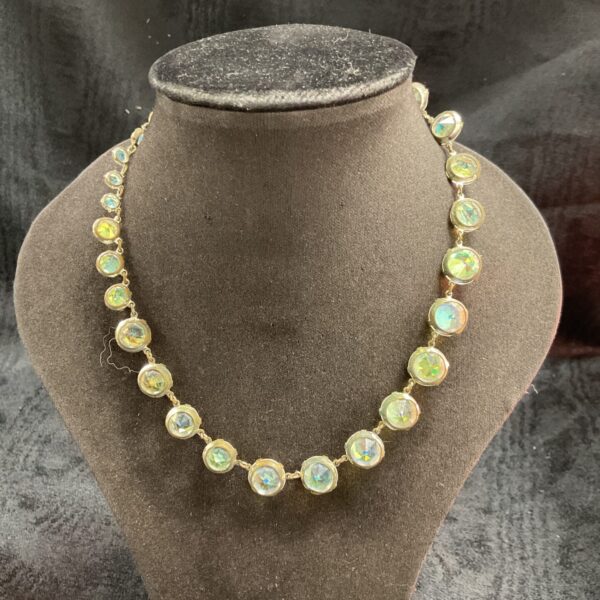 Close-up of vintage crystal necklace with gold settings.