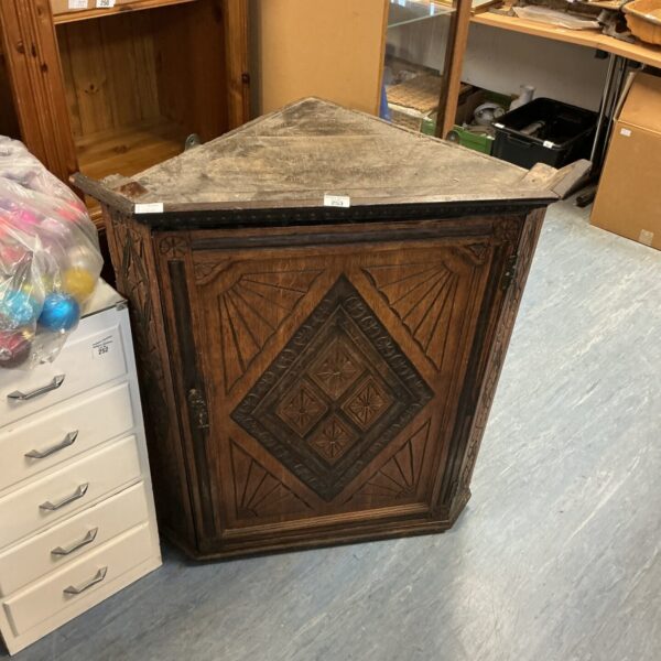Vintage dark oak corner wall cabinet with carved details.