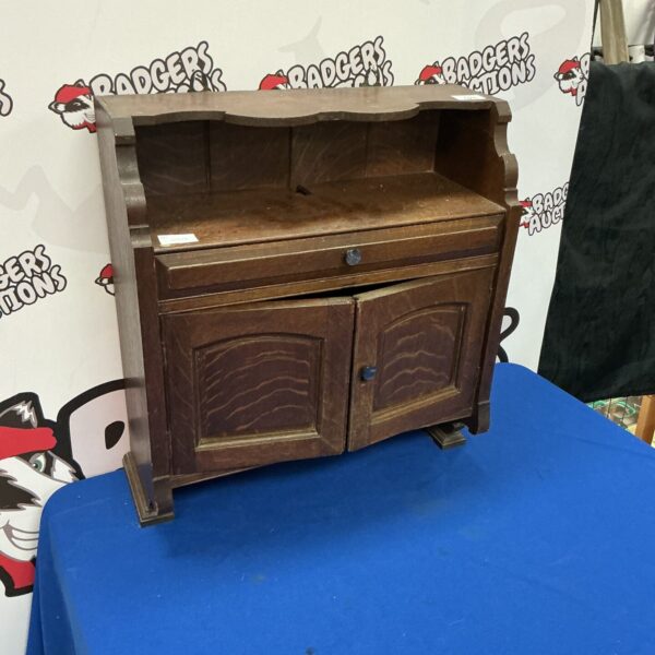 Vintage dark oak wall cabinet with a single door.