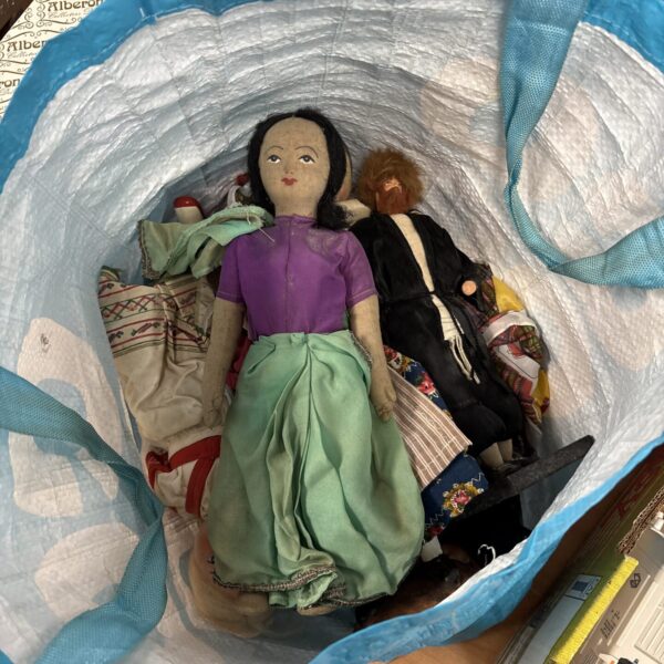 A lot of vintage cloth dolls with painted faces.