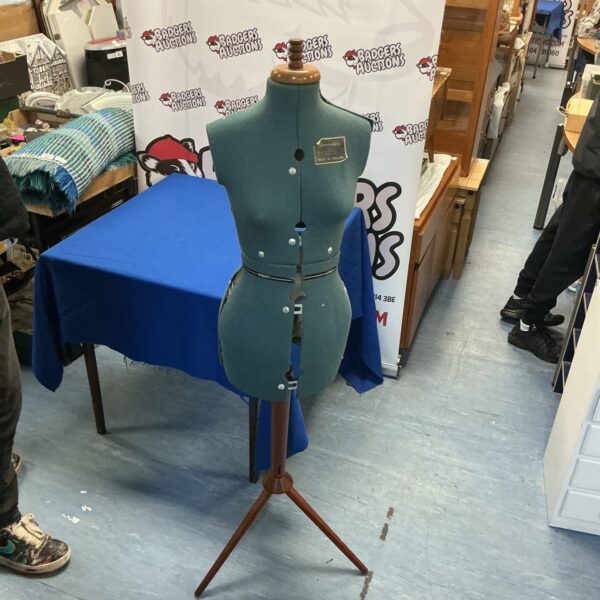 Vintage dressmaker manikin on wooden tripod base.