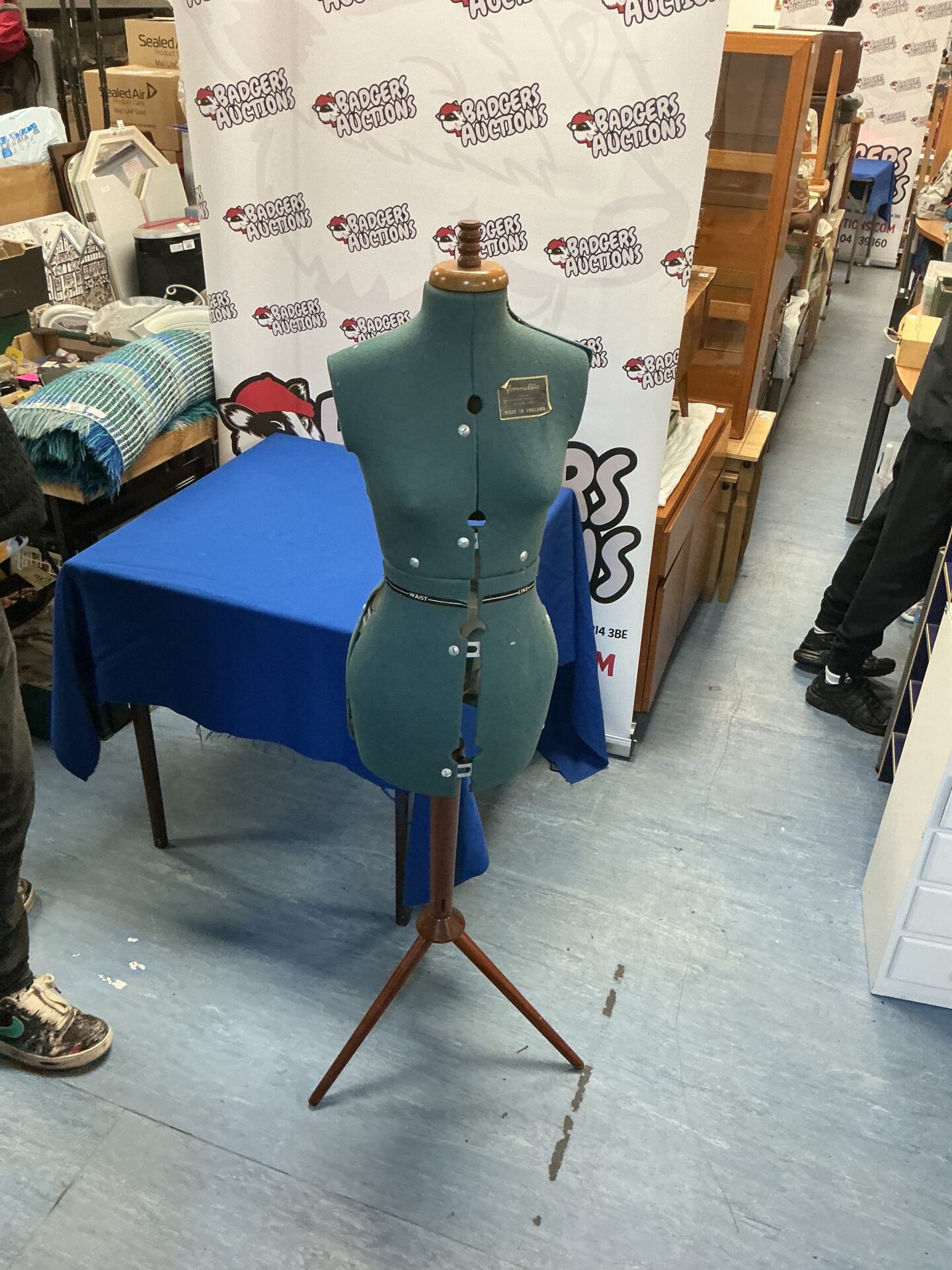 Vintage dressmaker manikin on wooden tripod base.