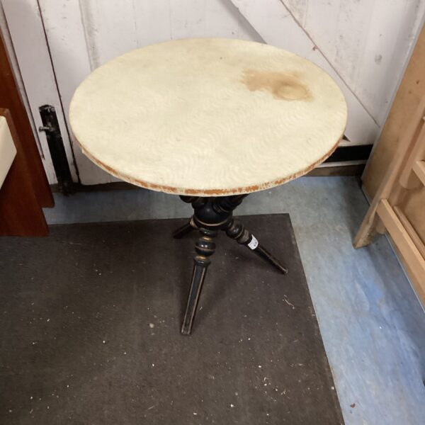 Vintage gypsy table with three legs and circular top.