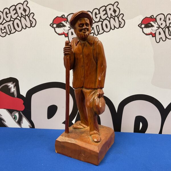 Front view of vintage hand-carved wooden travelling man figure.