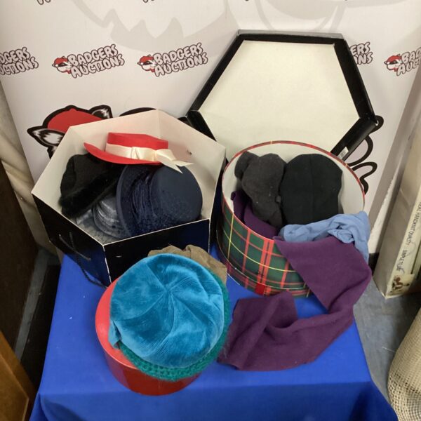 Vintage hats and scarves in hat boxes, a retro fashion collection.