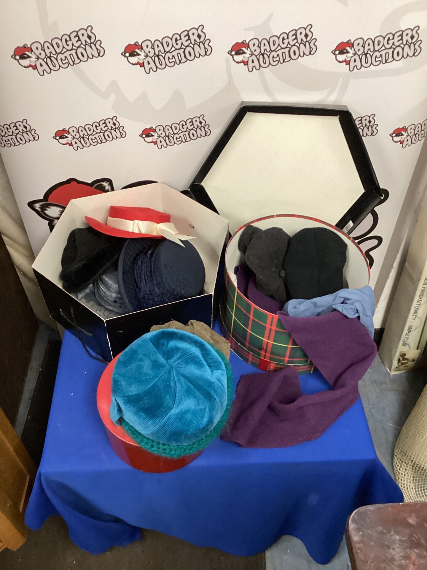 Vintage hats and scarves in hat boxes, a retro fashion collection.