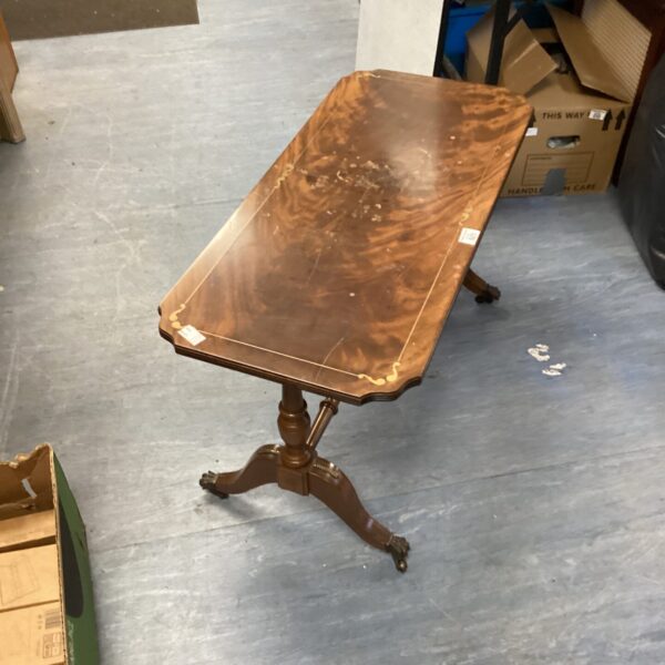 Vintage inlaid coffee table with claw feet and casters.