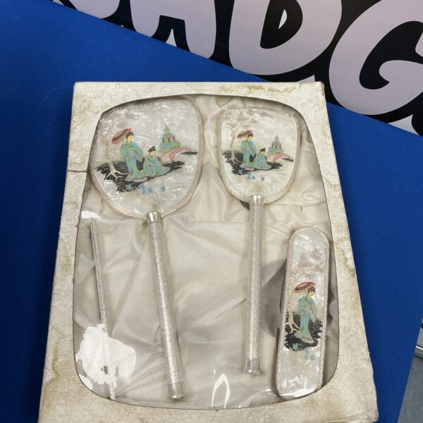 Vintage pair of Japanese hand mirrors with detailed designs.