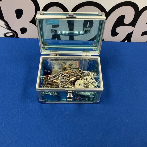 Vintage jewellery box filled with assorted jewellery and trinkets.