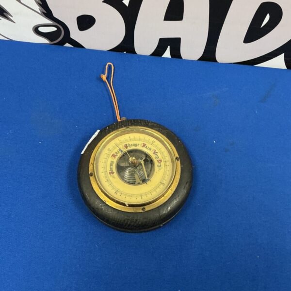 Vintage brass Lutti barometer for measuring atmospheric pressure.