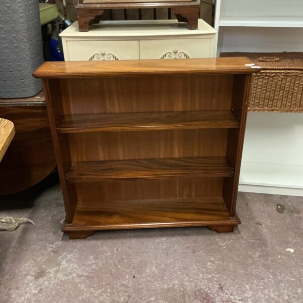 Vintage mahogany bookcase with two adjustable shelves for books.